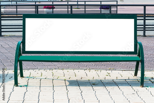 Billboard with blank white copy space for text message or content, mock up banner on a city bench, illuminated by sunlight 