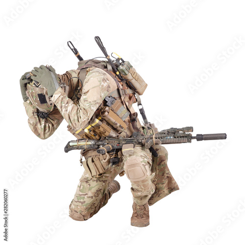 Infantryman hiding from explosion studio shoot isolated on white