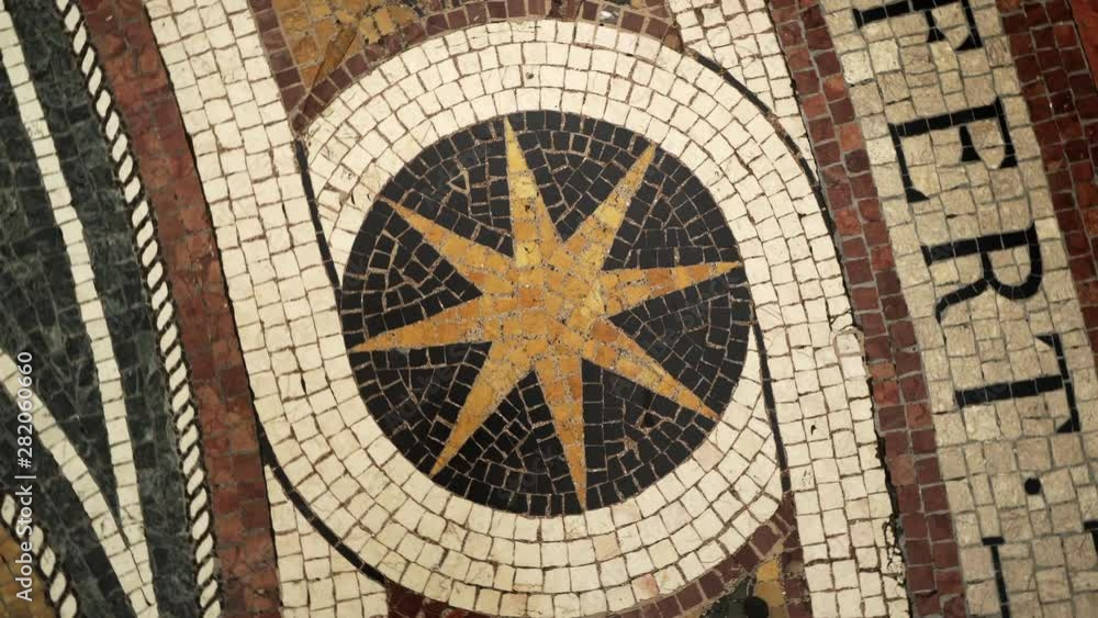 Spinning: Sun in the Floor of the Building In Milan Italy Drawn Using Tiles Spinning: Sun in the Floor of the Building In Milan Italy Drawn Using Tiles