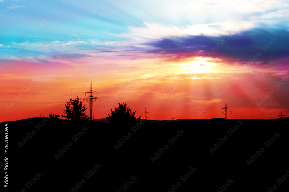 natural landscape with black silhouette of trees and a beautiful romantic sunset with rays natural landscape with black silhouette of trees and a beautiful romantic sunset with rays