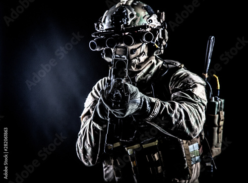 Army soldier aiming rifle i...