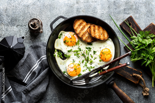 fried eggs in a cast iron pan top view