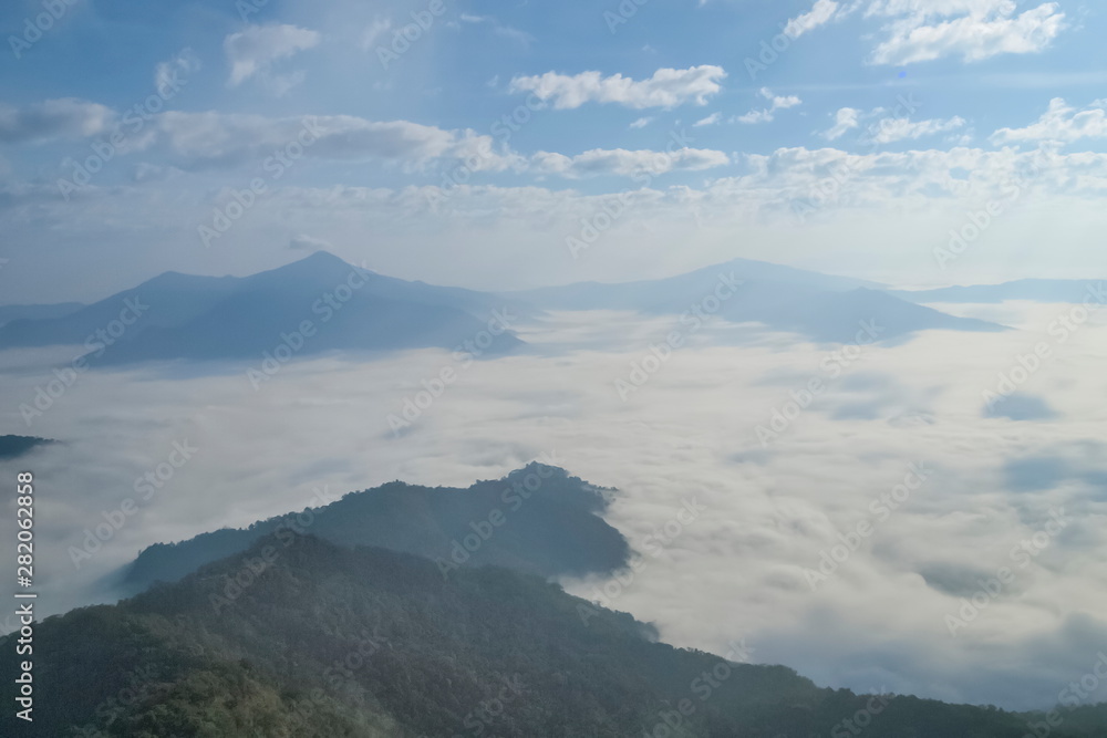 Mountain view misty morning of top hills around with sea of mist with cloudy sky background, sunrise at Pha Tang, Chiang Rai, northern of Thailand. Mountain view misty morning of top hills around with sea of mist with cloudy sky background, sunrise at Pha Tang, Chiang Rai, northern of Thailand.