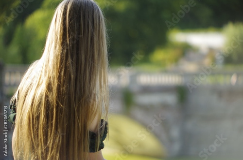  beautiful young blonde with long flowing hair and blue eyes in an old castle © Panas
