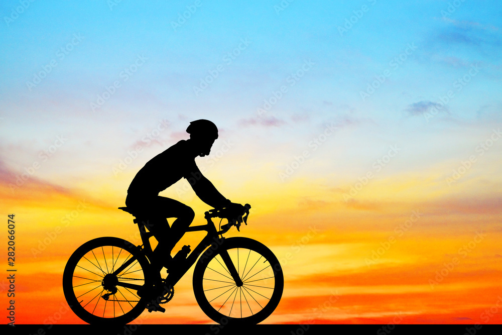 Fototapeta premium Silhouette Cycling on blurry sunrise sky background.