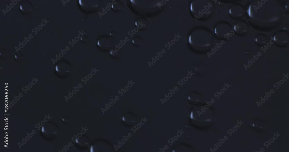 Color drops floating in oil and water over a colorful background Color drops floating in oil and water over a colorful background