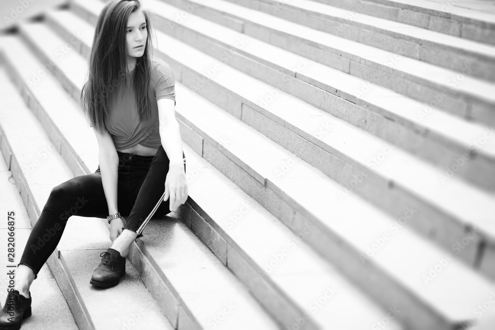 Obraz premium A girl posing on the steps of a building