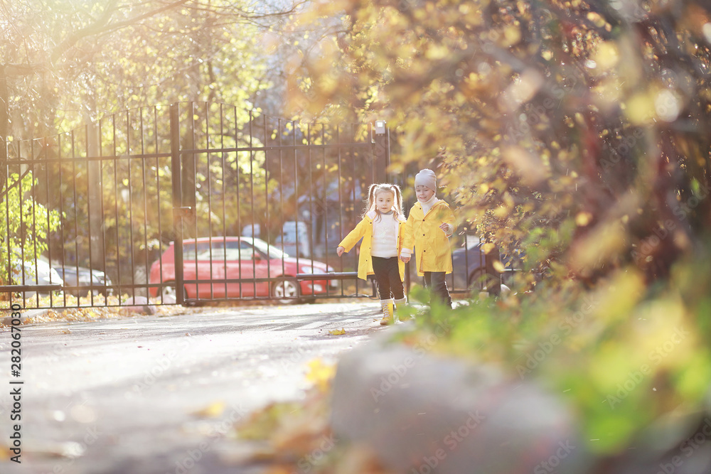 Children walk in the autumn park Children walk in the autumn park