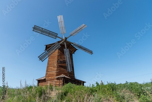 Old wooden windmill in a field