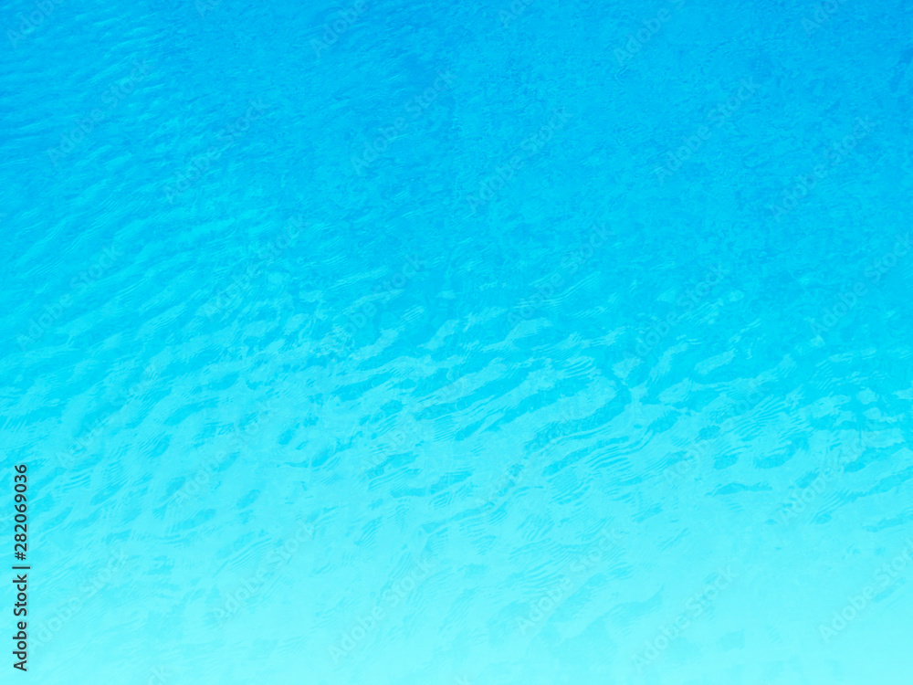 Blue background of water in swimming pool.
