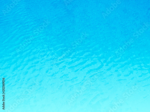 Blue background of water in swimming pool.