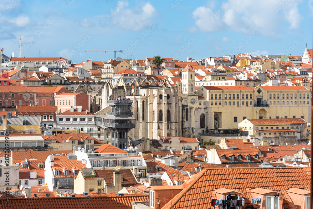 The roofs of the Baixa district with Lisbon historic elevator de Santa Justa and the Igreja do Carmo