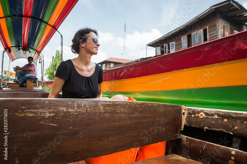 Photography Female tourist in a long tail boat in Bangkok, Thailand