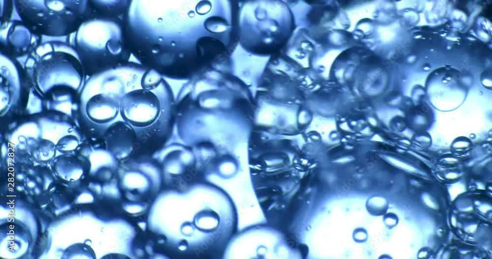 Color drops floating in oil and water over a colorful background Color drops floating in oil and water over a colorful background