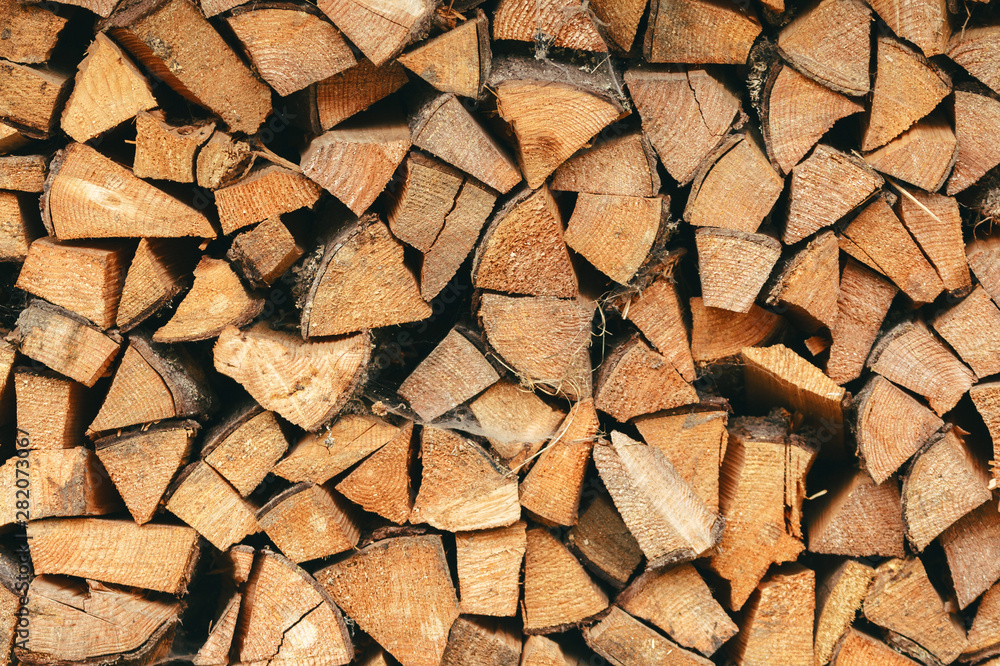 Wall of dry chopped firewood logs in a pile. The concept of rural life, summer harvesting for the winter, retro, wood, natural materials. Place for text, minimalism. Wall of dry chopped firewood logs in a pile. The concept of rural life, summer harvesting for the winter, retro, wood, natural materials. Place for text, minimalism.