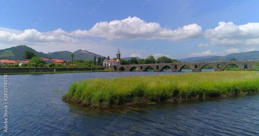 Aerial Forward Ascending: The Beautiful Area of Ponte De Lima on a Sunny Day with View of Small Church and Bridge - Ponte de Lima, Portugal Aerial Forward Ascending: The Beautiful Area of Ponte De Lima on a Sunny Day with View of Small Church and Bridge - Ponte de Lima, Portugal