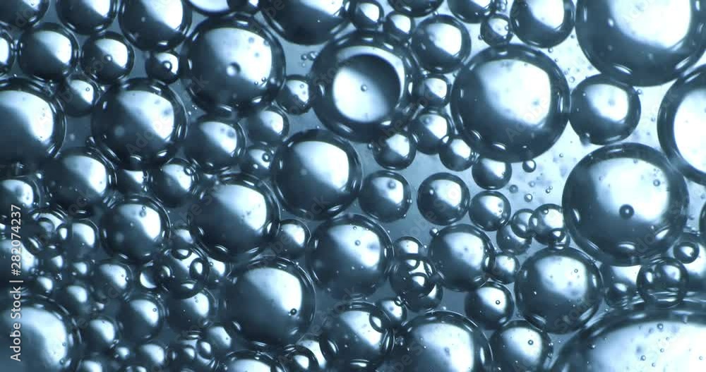 Color drops floating in oil and water over a colorful background Color drops floating in oil and water over a colorful background