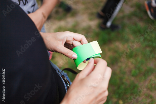 Green sticker roll in the hands of a girl