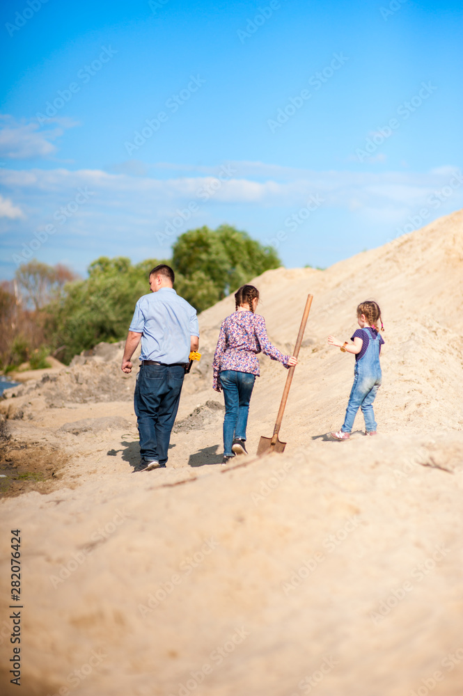 Family looking for treasure with a metal detector