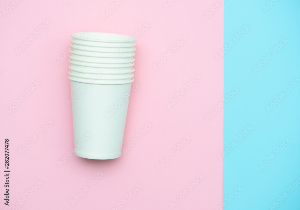 Paper white glasses for drinks and coffee. Glasses colored background Paper white glasses for drinks and coffee. Glasses colored background