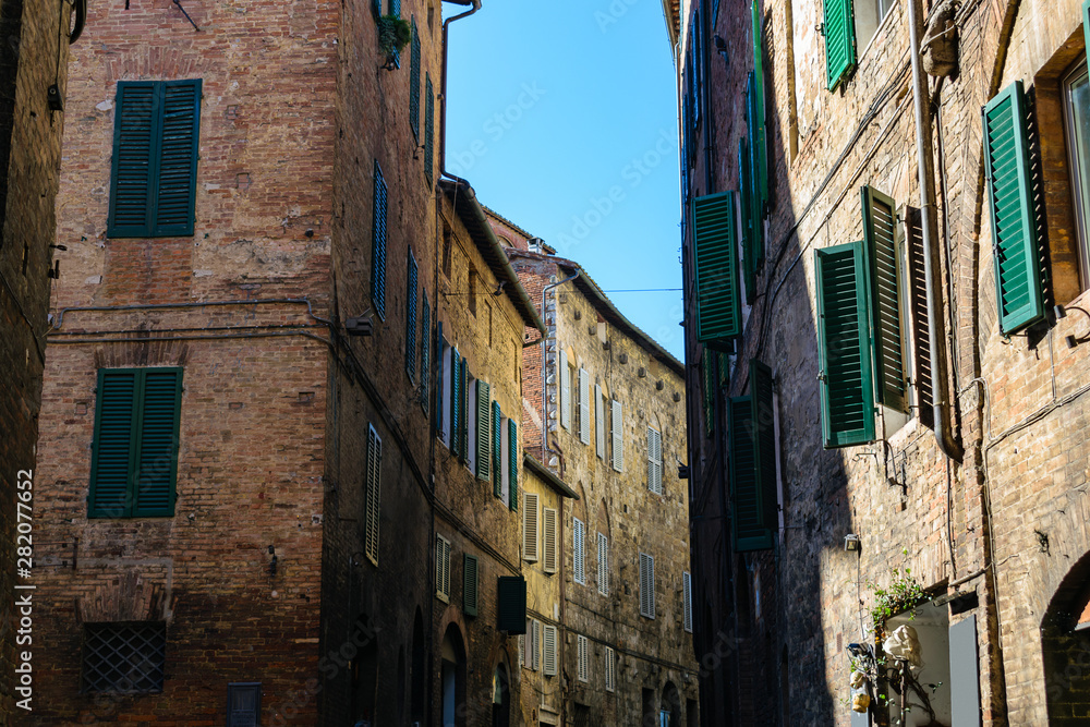 Medieval street in Siena city center, Italy