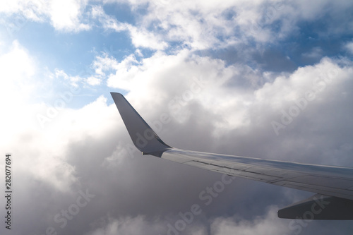 Wing of a Plane on Blue Sky Background.
