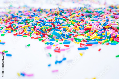 Colorful candy sprinkles close up for birthday cake on white background