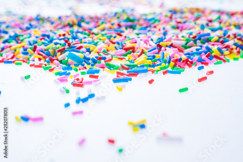 Colorful candy sprinkles close up for birthday cake on white background