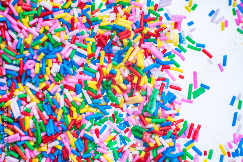 Colorful candy sprinkles close up for birthday cake on white background