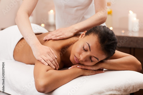 Portrait of blissful woman enjoying massage in luxury SPA, copy space
