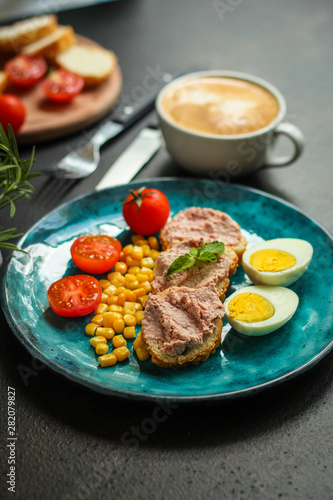 Breakfast snack, tasty food (pate, toast, tomato, corn, egg, coffee). top view. food background