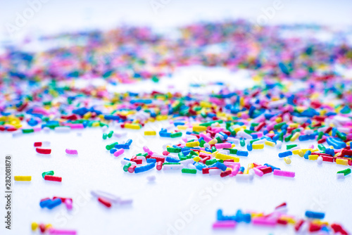 Colorful candy sprinkles close up for birthday cake on white background