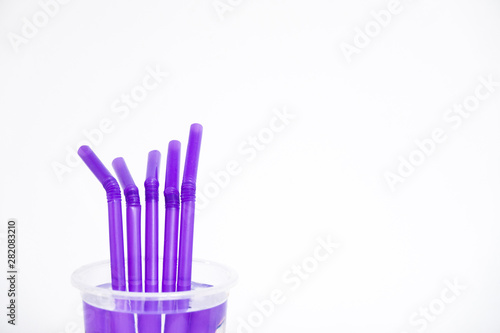 Purple straws isolated over a white background