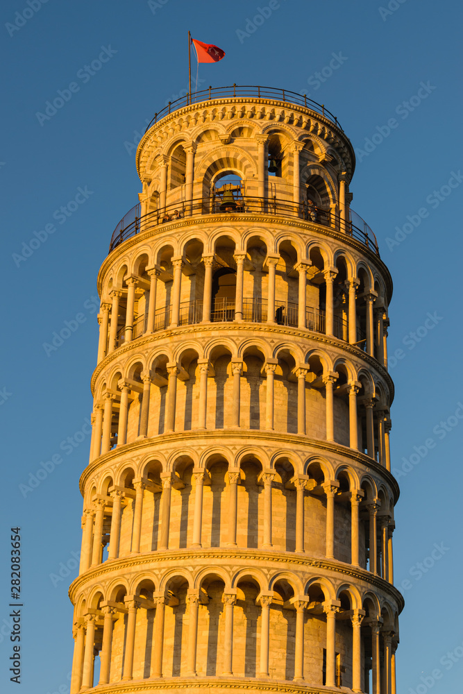 Detail of Pisa leaning tower at sunset, Italy