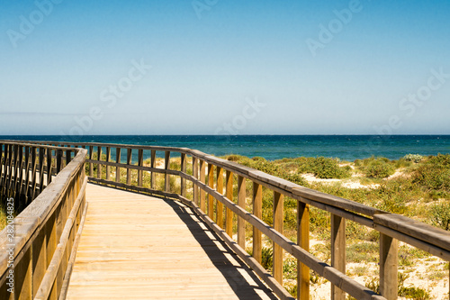 wooden path to the coast - sea, sand and plants © miriamgilalbert