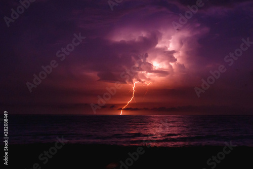 Lightning at night at sea.