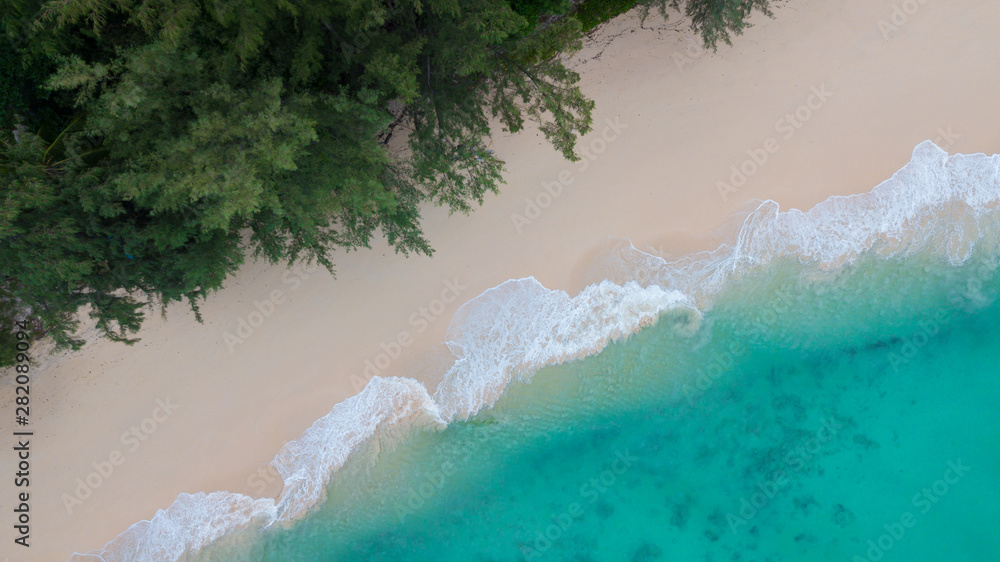 Aerial view of tropical Island white sand beach alonf the pine tree anf turqouise water at Koh Kradan Island, Trang, Thailand. Beach top view. 