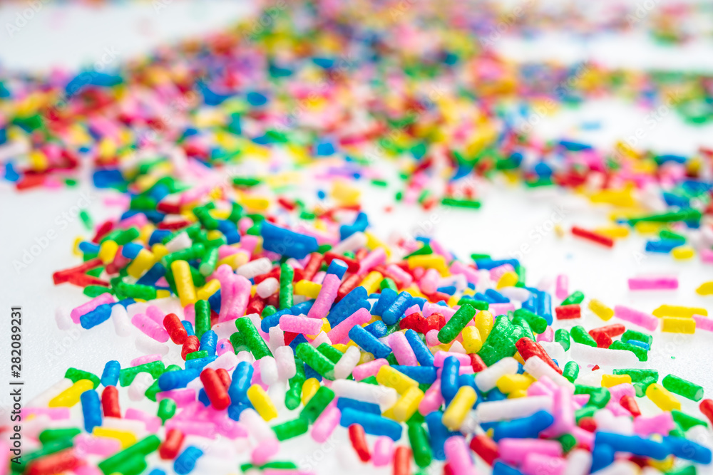 Fototapeta premium Colorful candy sprinkles close up for birthday cake on white background