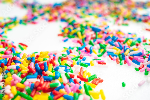 Colorful candy sprinkles close up for birthday cake on white background