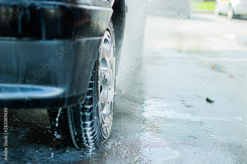 Modern car wash, dripping water and foam.