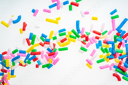 Fototapeta Naklejka Na Ścianę i Meble -  Colorful candy sprinkles close up for birthday cake on white background