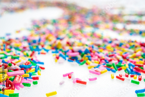 Colorful candy sprinkles close up for birthday cake on white background