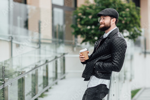 Wallpaper Mural A bearded, serious, stylish manager on the streets of the city near modern office centre and drinks coffee. Torontodigital.ca