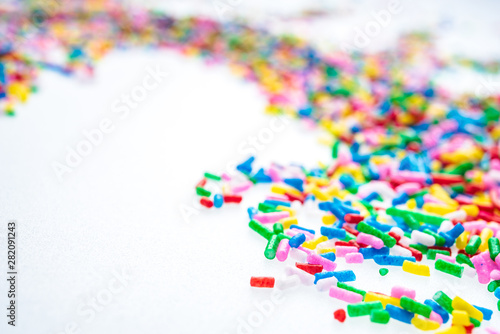 Colorful candy sprinkles close up for birthday cake on white background