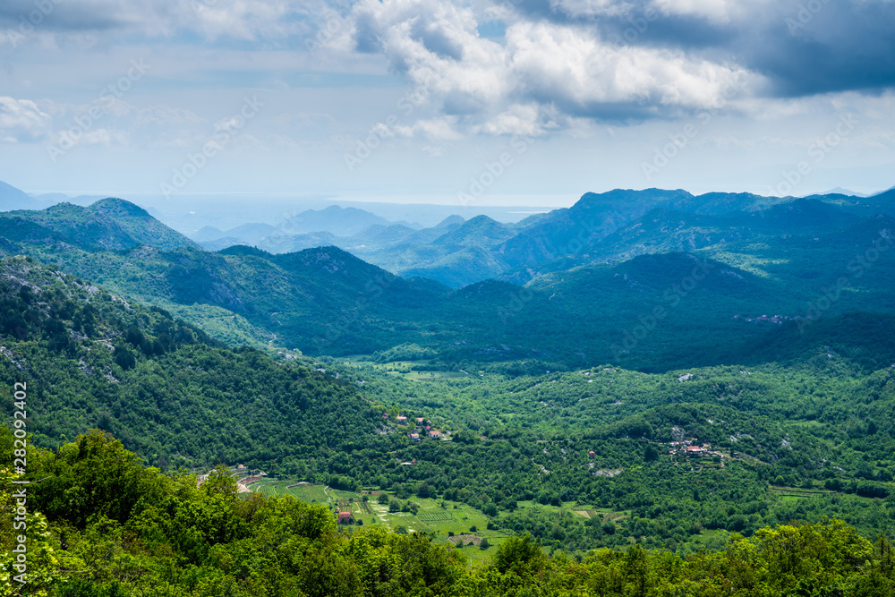Montenegro, Wide view above skadar valley scenery of mountains and hills covered by green trees and forest nature landscape in beautiful national park