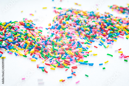 Colorful candy sprinkles close up for birthday cake on white background