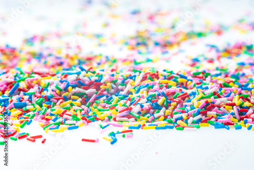 Colorful candy sprinkles close up for birthday cake on white background