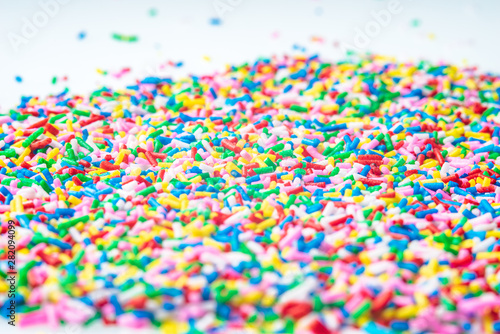 Colorful candy sprinkles close up for birthday cake on white background