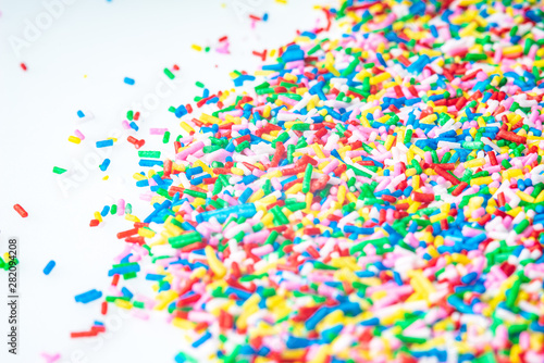 Colorful candy sprinkles close up for birthday cake on white background