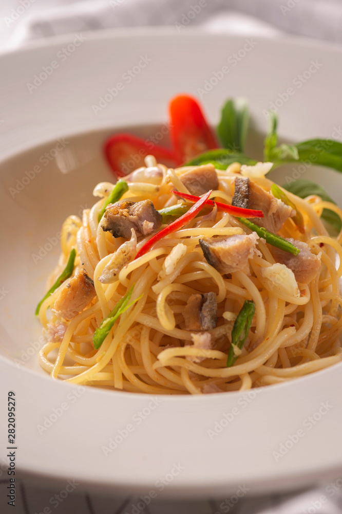 Salted fish spaghetti served in a white dish Salted fish spaghetti served in a white dish